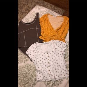 Three medium size shirts one bodysuit and two crop tops.